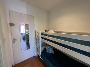 ラ・グランド・モットにあるApartment Du Soleil-4 by Interhomeの二段ベッドと鏡が備わる客室です。