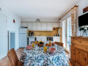 a kitchen with a table with fruit and orange juice at Apartment Les Sauvagières II-1 by Interhome in Cavalaire-sur-Mer