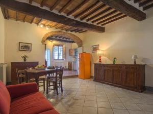 a kitchen and a living room with a table and a refrigerator at Apartment Campiglia-4 by Interhome in Tavarnelle in Val di Pesa