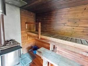 a wooden room with two bunk beds in it at Holiday Home Koskimökki by Interhome in Kortteinen