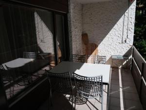 a table and chairs on the balcony of a building at Apartment Rustica by Interhome in Lenzerheide
