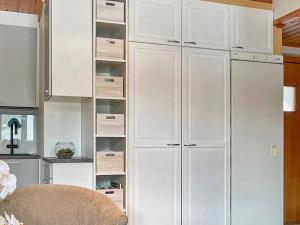 a white closet with white cabinets in a kitchen at Holiday Home Levin rinnelinna a8 by Interhome in Sirkka
