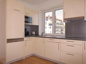 a kitchen with white cabinets and a window at Apartment Ladis-10 by Interhome in Ladis