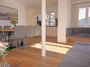 a living room with a couch and a table and chairs at Apartment Ladis-10 by Interhome in Ladis +53 photos