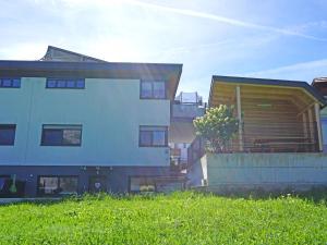 a group of buildings in a yard with grass at Apartment Ferienwohnung Sabine by Interhome in Oberperfuss
