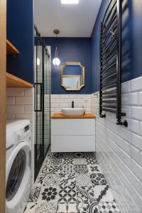 a bathroom with a sink and a washing machine at Salt Island Apartment Sea and Harbor View by Renters in Kołobrzeg