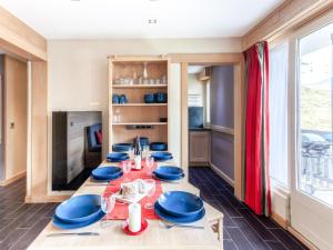 a dining room with a table with blue dishes on it at Apartment Le Bec Rouge - Le Lac-9 by Interhome in Tignes