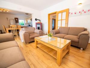 a living room with two couches and a coffee table at Holiday Home Villa Maria by Interhome in Donji Proložac