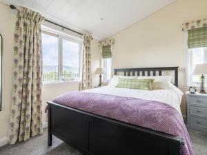 a bedroom with a bed and a window at Chalet Loch Leven Lodge 16 Robin's Nest by Interhome in Kinross +8 photos