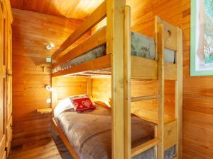 a bedroom with two bunk beds in a log cabin at Holiday Home Le Cafetan - Les Chartreux by Interhome in Tignes