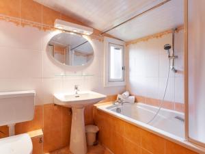 a bathroom with a sink and a bath tub at Holiday Home Le Cafetan - Les Chartreux by Interhome in Tignes