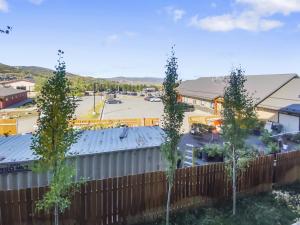 a fence with trees in front of a parking lot at Blackstone Beauty condo in Park City
