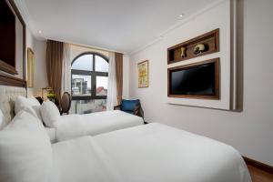 Voodi või voodid majutusasutuse The Q Hotel toas