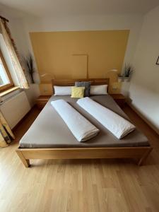 a large bed with two pillows on it in a bedroom at Ferienwohnung Gertraud und Peter Geisler in Finkenberg