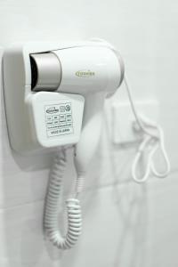 a white phone is hanging on a wall at Khách sạn Hà Giang Hotel in Ha Long +19 photos