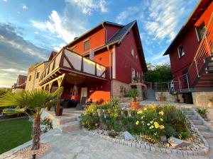 a red house with a garden in front of it at Ferienhaus Auenblick DELUXE in Eisenach