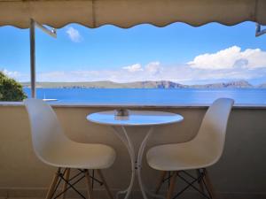 a dining room table with a view of the ocean at 12 Gods Resort in Pylos