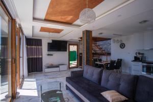 a living room with a couch and a table at Villa unforgettable in Sarajevo