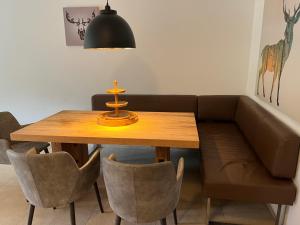 a dining room table with a couch and a table and chairs at Apartment Ski & Golf Suites Zell am See by Interhome in Zell am See