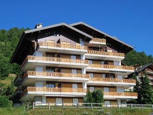 a building with balconies on the side of it at Apartment Les Crêtes 1-4 by Interhome in Veysonnaz