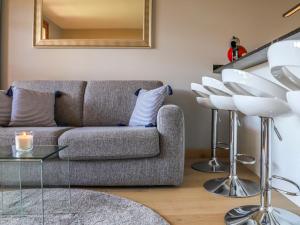a living room with a couch and a mirror at Apartment Chaperon Rouge A3 by Interhome in Chesières