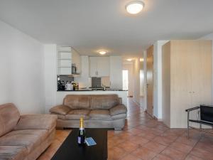 a living room with a couch and a table at Apartment Tasman S16-R by Interhome in Bouveret