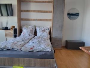 - une chambre avec un lit et une tête de lit en bois dans l'établissement Apartment Alpensicht by Interhome, à Höchenschwand