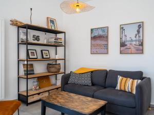 a living room with a couch and a table at Apartment Le Clos Moguer-2 by Interhome in Quiberon +14 photos