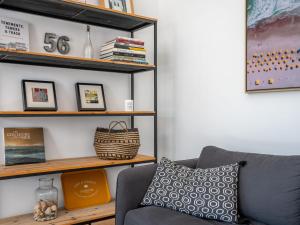 a living room with a couch and a shelf at Apartment Le Clos Moguer-2 by Interhome in Quiberon