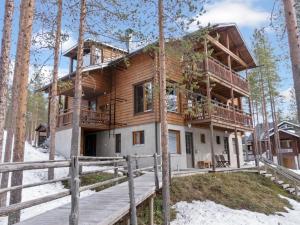 a log cabin in the woods with a wooden deck at Holiday Home Nuovo casa b by Interhome in Sirkka