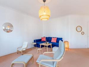 a living room with a blue couch and chairs at Apartment L'écluse-2 by Interhome in Dinard +13 photos