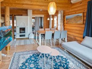 a living room with a table and a couch at Holiday Home Lompakko by Interhome in Äkäslompolo