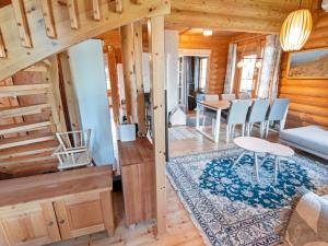 a living room and dining room in a log cabin at Holiday Home Lompakko by Interhome in Äkäslompolo