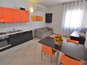 a kitchen and living room with a table and chairs at Apartment Rosapanna-2 by Interhome in Rosapineta