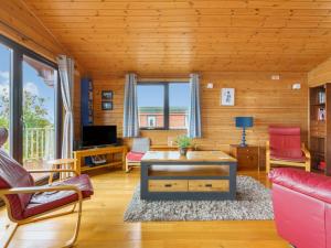 a living room with a couch and a table at Chalet Lodge 9 by Interhome in Kinross