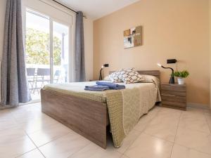 a bedroom with a bed and a large window at Apartment Puigmal by Interhome in Empuriabrava