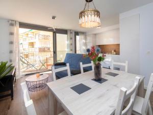 a dining room table with a vase of flowers on it at Apartment Isea Calpe-5 by Interhome in Calpe +19 photos