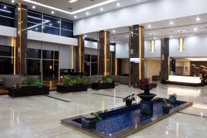 a lobby with a fountain in the middle of a building at Best Western Plus Coco Palu in Palu