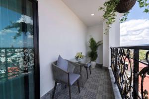 a balcony with a table and chairs on it at SureStay Hotel by Best Western Vientiane in Vientiane