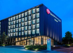 a building with a sign in front of it at Best Western Plus Nexen Pattaya in Pattaya Central