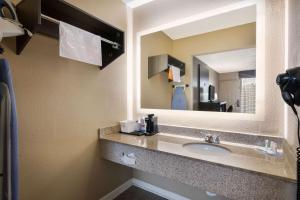a bathroom with a sink and a mirror at Quality Inn in Gastonia +44 photos