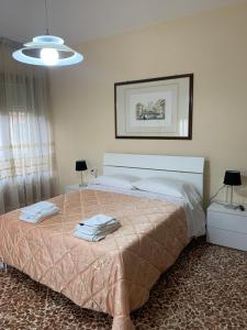 a bedroom with a large bed with a pink blanket at Hotel Chenno in Subbiano