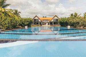 an image of a swimming pool in front of a villa at Uga Bay - Pasikuda in Pasikuda