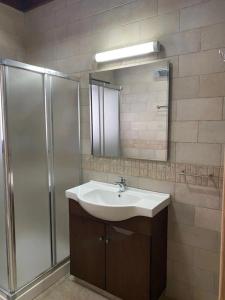 a bathroom with a sink and a shower at Stavros Country House in Siá