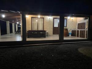 a view of a house with a patio at night at Stavros Country House in Siá