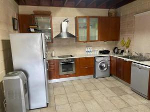 a kitchen with a refrigerator and a washing machine at Stavros Country House in Siá