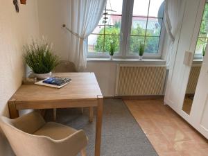 a dining room with a table and chairs and a window at Fischer un sin Fru in Klein Zicker