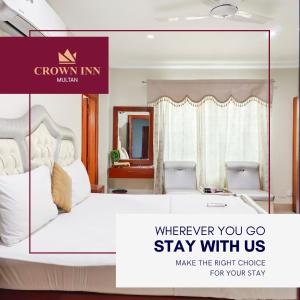 a bedroom with a bed and a sign that says wherever you go stay with us at Hotel Crown Inn Multan in Multan