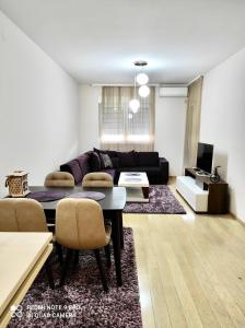 a living room with a couch and a table at Apartment City Kvart Podgorica in Podgorica