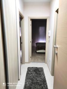 a hallway with a door leading into a room at Apartment City Kvart Podgorica in Podgorica +1 photo